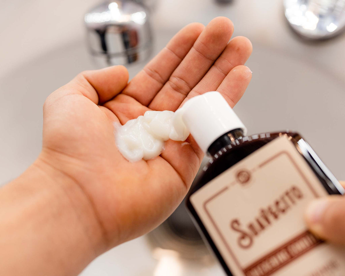 thickening conditioner being squeezed into palm