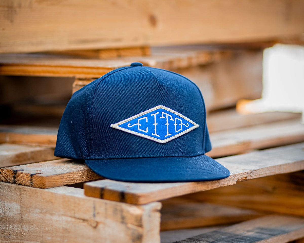 blue suavecito hat with white embroidered text and blue background "cito" in diamond shape