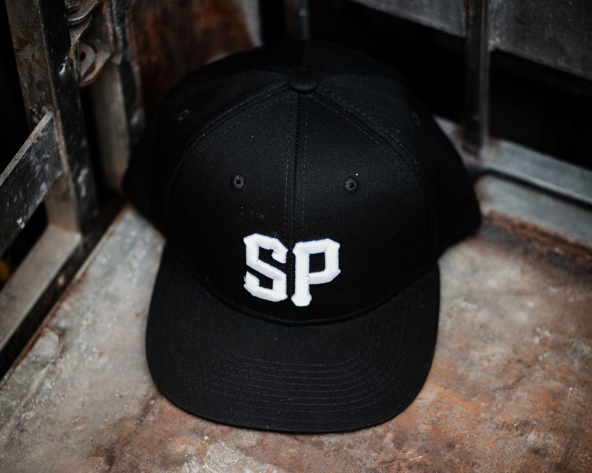 black suavecito hat with white embroidered text "SP"