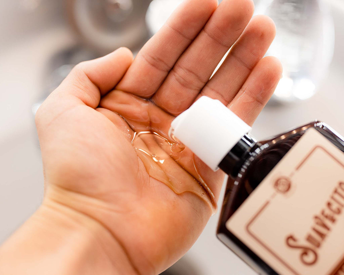 Thickening shampoo being squeezed into palm of hand 